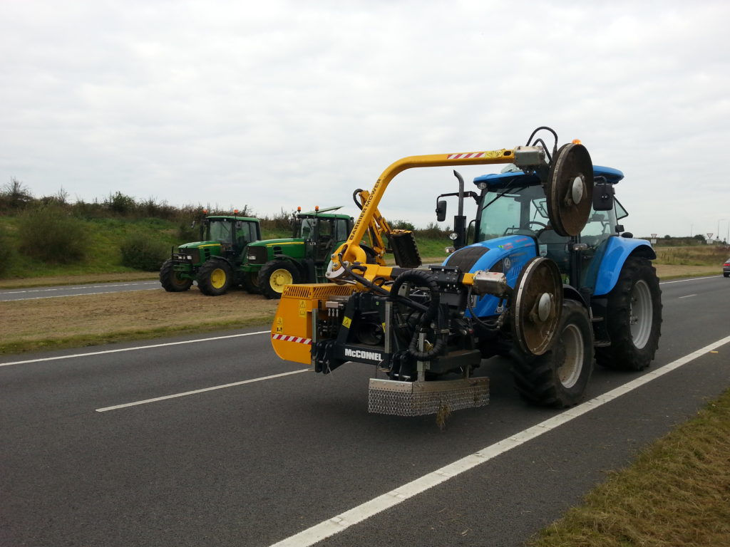 Barrier mower mounted on a tractor on the A55